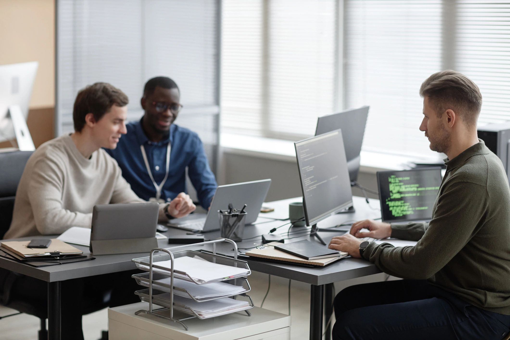 Programming team collaborating in a modern office
