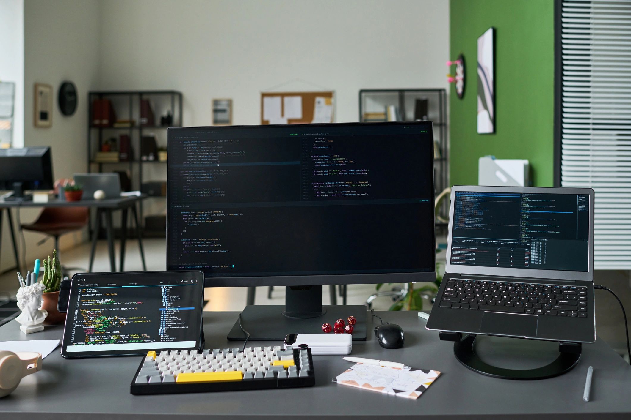 Programming workspace with code displayed on multiple screens